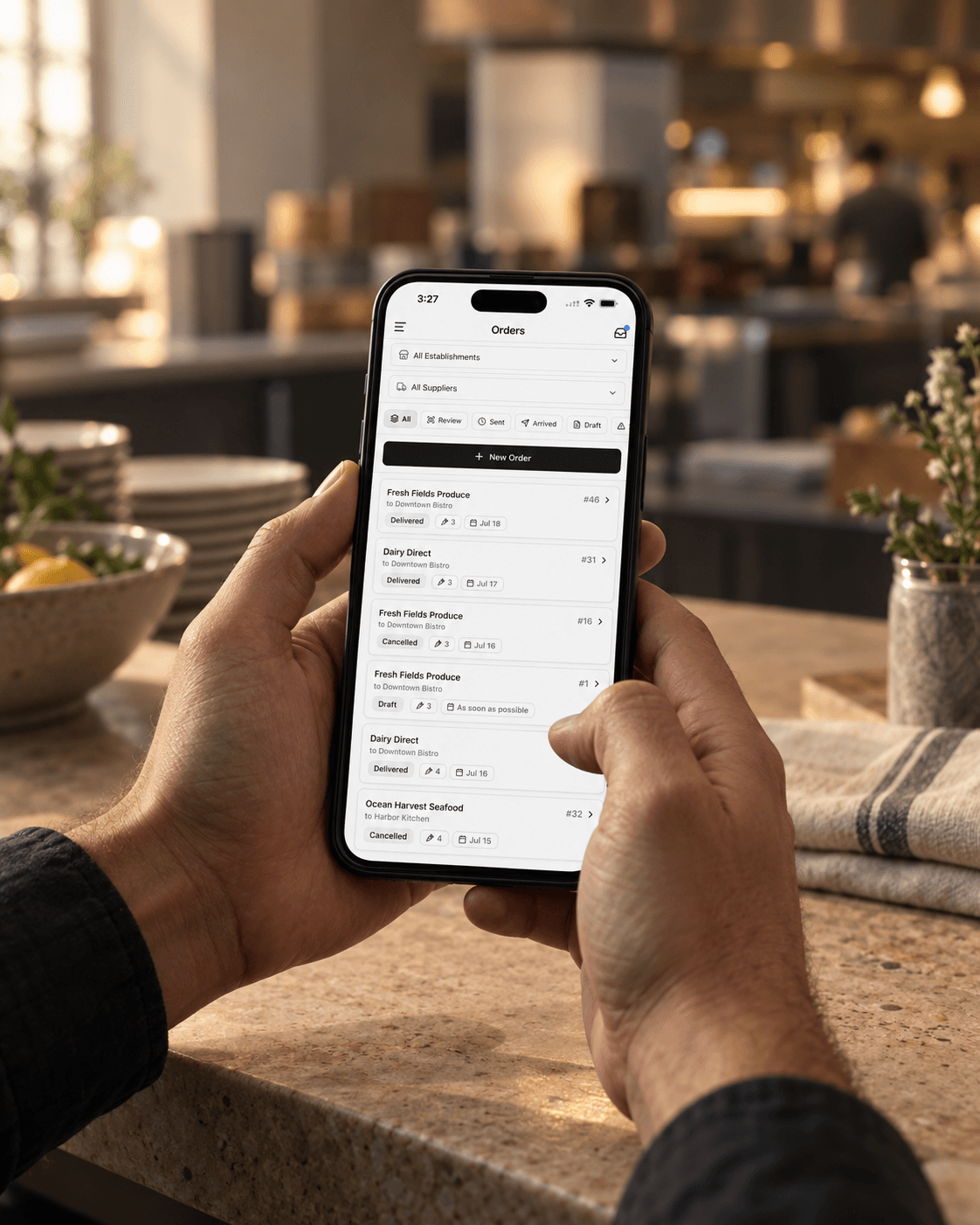 A hand holding a phone with Spensa supplier orders on screen